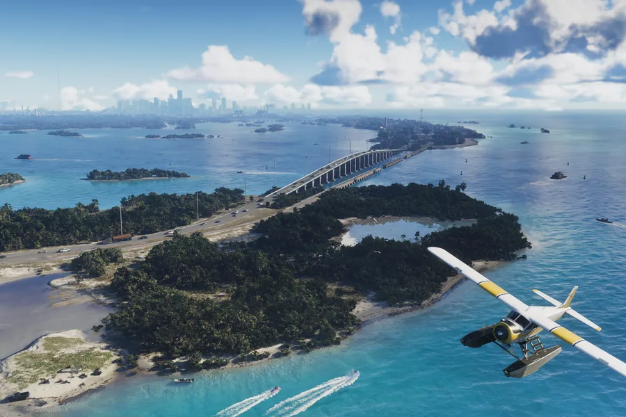 Aerial view over the Leonida Keys: a causeway bridge linking wooded islands across turquoise water, a seaplane in the foreground and a distant city skyline on the horizon.