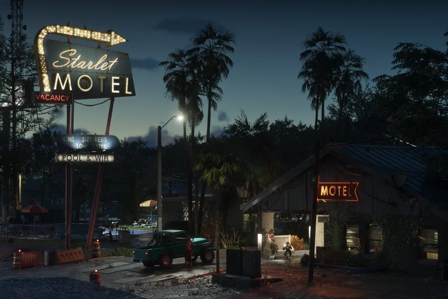 The lit sign of the Starlet Motel at dusk, above a low motel building among palm trees, a green pickup parked at the entrance.